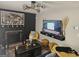 Comfortable living room with dark accent wall, fireplace, and entertainment center with TV at 6558 Eastbriar Dr, Lithonia, GA 30058