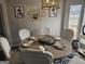 Bright dining room with seating for six, featuring stylish decor and natural light from a window at 6558 Eastbriar Dr, Lithonia, GA 30058