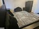Comfortable bedroom featuring a large bed with plush pillows and black nightstands at 6558 Eastbriar Dr, Lithonia, GA 30058