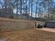 Large backyard featuring a stone retaining wall and a gazebo with an outdoor grill at 6558 Eastbriar Dr, Lithonia, GA 30058