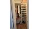 Organized closet featuring shelving for shoes and hanging space for clothing, with hardwood flooring at 6558 Eastbriar Dr, Lithonia, GA 30058