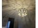Elegant chandelier casting light in a room with dark curtains at 6558 Eastbriar Dr, Lithonia, GA 30058