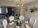 Stylish dining room with modern lighting, table setting, and open view to the adjacent living area at 6558 Eastbriar Dr, Lithonia, GA 30058