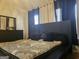 Sleek bedroom with black furniture, plush pillows, and ambient lighting at 6558 Eastbriar Dr, Lithonia, GA 30058