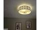 Close-up of bedroom ceiling with modern light fixture and decorative wall art at 6558 Eastbriar Dr, Lithonia, GA 30058