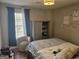 Bedroom featuring large window, comfy chair, and modern wardrobe at 6558 Eastbriar Dr, Lithonia, GA 30058
