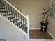 View of the property staircase with wood steps, white posts and black metal railing at 6558 Eastbriar Dr, Lithonia, GA 30058