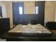 Modern bedroom featuring a large bed with black furnishings and plush decorative pillows at 6558 Eastbriar Dr, Lithonia, GA 30058
