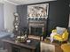 Inviting living room with a brick fireplace, decorative artwork, and comfortable seating for a welcoming ambiance at 6558 Eastbriar Dr, Lithonia, GA 30058