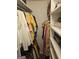 Walk-in closet with organized shelving and hanging racks, filled with a variety of clothing items at 6558 Eastbriar Dr, Lithonia, GA 30058