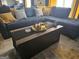 Comfortable living room featuring a sectional sofa, decorative pillows, and a modern coffee table setup at 6558 Eastbriar Dr, Lithonia, GA 30058