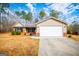 Charming single-story home featuring a two-car garage, manicured landscaping, and a classic brick facade at 225 Mertis Ln, Carrollton, GA 30116