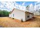 Exterior of house with vinyl siding and a grassy, sparsely vegetated yard at 225 Mertis Ln, Carrollton, GA 30116