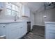 Modern kitchen boasts stainless steel dishwasher and bright white countertops and cabinets with wood-look floors at 225 Mertis Ln, Carrollton, GA 30116