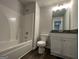 Bathroom featuring a white vanity, toilet and tiled shower at 140 Tye St, Stockbridge, GA 30281