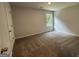 Bedroom with neutral walls and carpet, with a window that provides natural light at 140 Tye St, Stockbridge, GA 30281