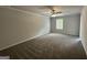 Bright bedroom featuring neutral paint, plush carpeting, and a ceiling fan at 140 Tye St, Stockbridge, GA 30281