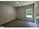 Bedroom with neutral walls, carpet flooring, and a large window at 140 Tye St, Stockbridge, GA 30281