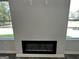 Modern fireplace with a black frame, set against a light gray wall at 140 Tye St, Stockbridge, GA 30281