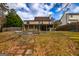 Large backyard featuring a covered porch, stone patio, and a mature landscape at 270 Sturgess Run, Sharpsburg, GA 30277
