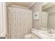 Bathroom featuring beige walls, light cabinetry, and a shower with a patterned curtain at 270 Sturgess Run, Sharpsburg, GA 30277