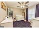 Bedroom featuring a crib, ceiling fan, and dark rug at 270 Sturgess Run, Sharpsburg, GA 30277