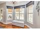 Bright breakfast nook featuring three windows, gray walls, hardwood floors and a bench seat at 270 Sturgess Run, Sharpsburg, GA 30277