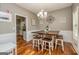 Charming dining room with hardwood floors, wainscoting, modern chandelier, and a wooden table at 270 Sturgess Run, Sharpsburg, GA 30277