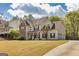 Two-story home with stone accents, an attached garage, a driveway, and a well-maintained lawn at 270 Sturgess Run, Sharpsburg, GA 30277