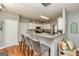 Kitchen featuring bar seating, wooden floors, white cabinets, gray walls and decor at 270 Sturgess Run, Sharpsburg, GA 30277