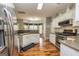 Kitchen with stainless steel appliances, wooden floors, and gray walls at 270 Sturgess Run, Sharpsburg, GA 30277