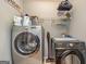 Functional laundry room featuring a side-by-side washer and dryer and overhead storage shelf at 270 Sturgess Run, Sharpsburg, GA 30277
