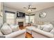 Cozy living room with hardwood floors, fireplace, comfortable seating, and ample natural light at 270 Sturgess Run, Sharpsburg, GA 30277