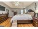 Comfortable main bedroom with wood floors, tray ceiling, and matching furniture at 270 Sturgess Run, Sharpsburg, GA 30277