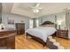 Comfortable main bedroom with wood floors, tray ceiling, and dark furniture at 270 Sturgess Run, Sharpsburg, GA 30277