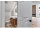 Modern bathroom with wood vanity, a round illuminated mirror, and tile flooring at 859 N Bay Overlook, Villa Rica, GA 30180