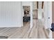 Elegant open-concept home featuring wood floors, decorative beams and a view into the modern kitchen at 859 N Bay Overlook, Villa Rica, GA 30180
