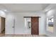 Stylish main bedroom features a barn door to the bathroom and walk-in closet and hardwood floors at 859 N Bay Overlook, Villa Rica, GA 30180