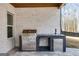 The outdoor kitchen features a built-in stainless steel grill, sink, and refrigerator, perfect for entertaining at 859 N Bay Overlook, Villa Rica, GA 30180