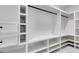 Custom walk-in closet with multiple shelves, drawers, and hanging rods to maximize storage at 859 N Bay Overlook, Villa Rica, GA 30180