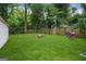 Large, well-maintained backyard with mature trees, a fire pit, and a shed at 1273 Boulevard Lorraine Sw, Atlanta, GA 30311