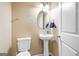Charming powder room featuring a pedestal sink, toilet, and decorative mirror at 1273 Boulevard Lorraine Sw, Atlanta, GA 30311