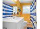 Bathroom featuring a white vanity and blue and white striped shower curtain at 1273 Boulevard Lorraine Sw, Atlanta, GA 30311