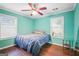 Bright bedroom with a ceiling fan, hardwood floors, and natural light from two windows at 1273 Boulevard Lorraine Sw, Atlanta, GA 30311