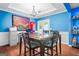 Bright dining room with a large table, hardwood floors, and colorful artwork at 1273 Boulevard Lorraine Sw, Atlanta, GA 30311