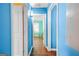 Hallway with white doors leading to rooms with bright blue paint at 1273 Boulevard Lorraine Sw, Atlanta, GA 30311