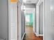 Hallway with wood floors leads to a bedroom with natural light from the window at 1273 Boulevard Lorraine Sw, Atlanta, GA 30311