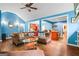 Open-concept living room with hardwood floors, comfortable seating, and bright blue walls at 1273 Boulevard Lorraine Sw, Atlanta, GA 30311