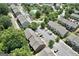 Community view featuring townhomes, a central pool, mature trees and parking at 1406 Bayrose Cir # 6B, East Point, GA 30344