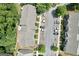 Overhead shot of residences with ample parking; surrounded by dense foliage and manicured lawns at 1406 Bayrose Cir # 6B, East Point, GA 30344